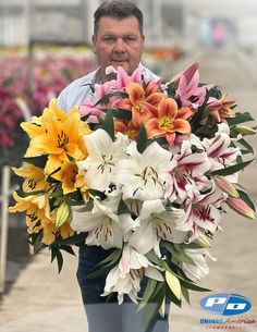 a man holding a large bouquet of flowers