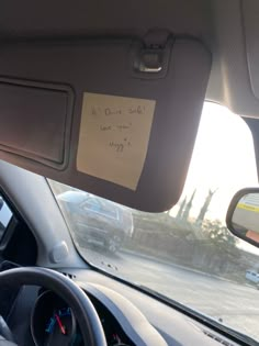 the driver's seat in a car with a note attached to it