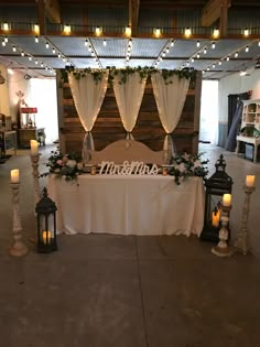 a table is set up for a wedding reception with candles and flowers on the table