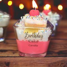 a birthday cake candle sitting on top of a wooden table