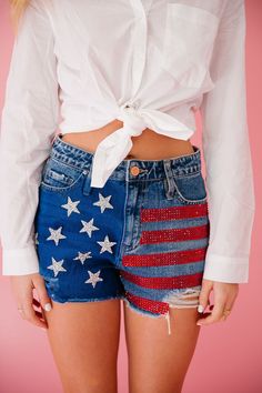 Show off your patriotic side with these American Flag Denim Shorts! Made from distressed denim, these shorts feature bold red rhinestone stripes, silver star patches, and a unique touch of blue paint. Perfect for any summer celebration or just adding some extra flair to your outfit! This is a made-to-order item. All cu Star Patches, Summer Celebration, Red Rhinestone, Blue Paint, Silver Stars, Distressed Denim, American Flag, Denim Shorts, Flag