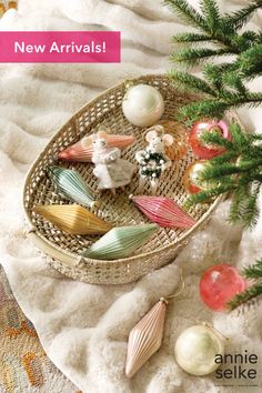 a basket filled with ornaments on top of a blanket