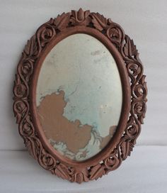 an old mirror is hanging on the wall