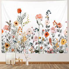 a wall hanging with flowers on it in an empty room