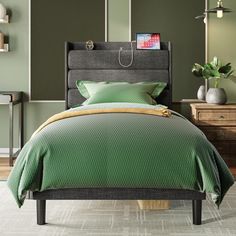 a bed with green sheets and pillows in a room