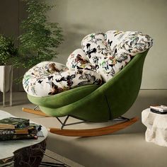 a green rocking chair with pillows on it