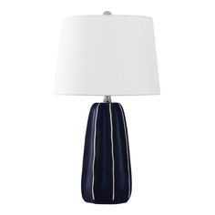 a table lamp with a white shade on it and a blue striped vase in the middle