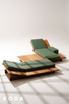 a green couch sitting on top of a wooden platform