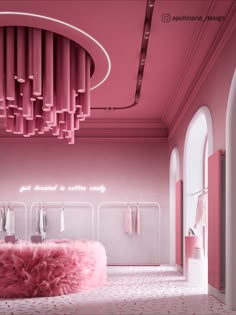 a pink room with lots of clothes hanging from the ceiling