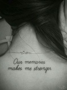 the back of a woman's neck with a tattoo saying our memories makes me stronger