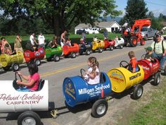 children's toy cars are lined up on the street and in front of them