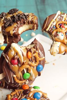 chocolate covered pretzels with candy and m & ms on them are ready to be eaten