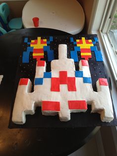 a cake made to look like an old video game controller with red, yellow and blue squares on it