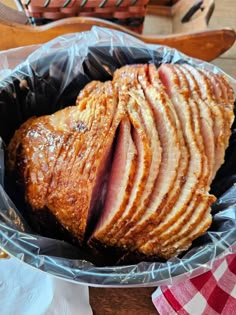 sliced ham sitting in a pan on top of a wooden table