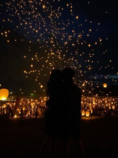 the sky is filled with hundreds of lanterns