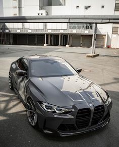 a black sports car parked in front of a building