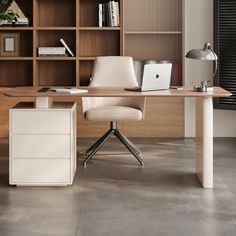 an office desk with a laptop on it and bookshelves in the back ground