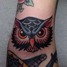 an owl and fish tattoo on the foot