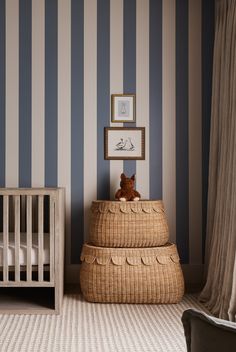 a baby's room with blue and white striped walls