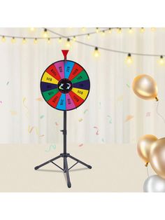 a spinning wheel with balloons and streamers in the background