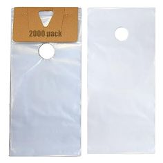 two white plastic bags with holes on the front and back of each bag, one has a brown cardboard tag attached to it