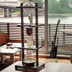 a table that has some kind of science experiment on it, in front of a window