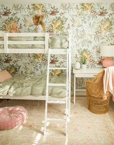 a bedroom with two bunk beds and a pink floor rug in front of the bed