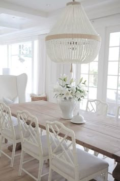 an instagramted photo of a dining room table with chairs and a chandelier