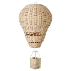 a rattan hot air balloon hanging from a white wall with a basket attached to it