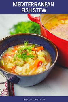 a bowl of fish stew with carrots and celery next to a pot of soup