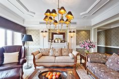 a living room filled with furniture and a chandelier