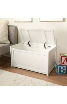 a white toy chest sitting on top of a wooden floor