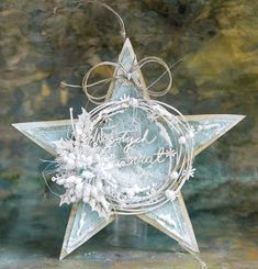 a glass star ornament with an inscription on it