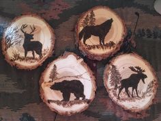 four pieces of wood with animals painted on them