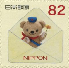 a postage stamp with an image of a teddy bear holding a flower in its envelope