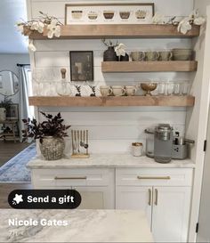 a kitchen with white cabinets and open shelves