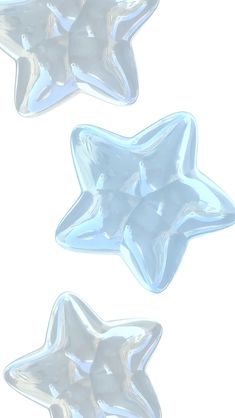 three shiny glass stars on a white background