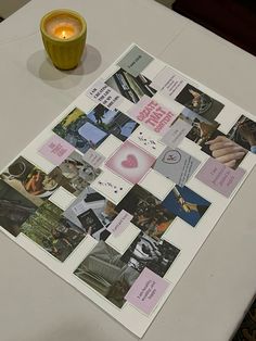 a white table topped with a cup filled with liquid and pictures on top of it