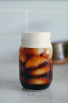 a jar filled with liquid sitting on top of a counter