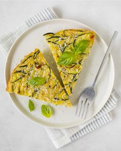 two slices of quiche on a plate with a fork