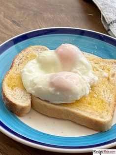 an egg is on top of toast on a blue and white plate