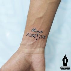 a person's wrist with the words think positive written on it, in black ink