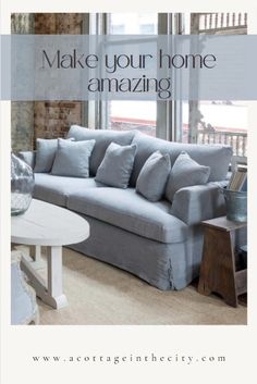 a living room with a gray couch and white coffee table in front of a window