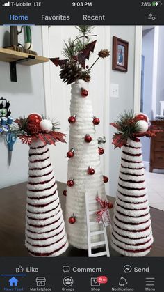 three christmas trees made out of yarn with decorations on them and one has a ladder