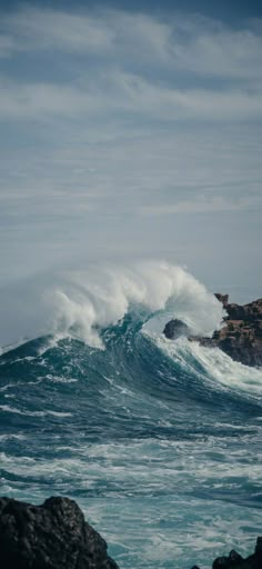 a large wave is coming towards the shore