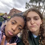 two girls are posing for the camera with their fingers up