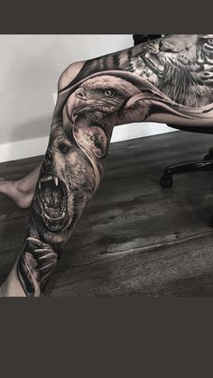 a man's leg with tattoos on it and an image of a bear in the middle