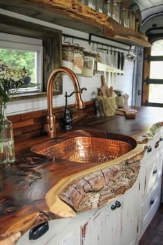 a kitchen sink made out of wood with a copper faucet on the counter