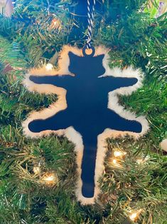 a blue ornament hanging from a christmas tree