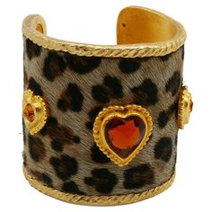 EDOUARD RAMBAUD vintage gold toned cuff bracelet featuring a faux leopard skin and three gold toned hearts embellished with crystals. Embossed EDOUARD RAMBAUD Paris. Indicative measurements : inner circumference approx. 16.34 cm (6.43 inches) / width approx. 5.8 cm (2.28 inches) / cuff opening approx. from 3 cm to 3.7 cm (from 1.18 inches to 1.46 inches). NOTES - This is a preloved vintage item, therefore it might have imperfections. - Colors may differ slightly from actual product appearance du Luxury Vintage Cuff Bracelet For Women, Vintage Cuff Bracelets Collectible, Luxury Vintage Cuff Jewelry, Luxury Vintage Cuff Bracelet, Luxury Vintage Statement Bracelets, Leopard Bracelet, Leopard Skin, Cheetahs, Funky Jewelry